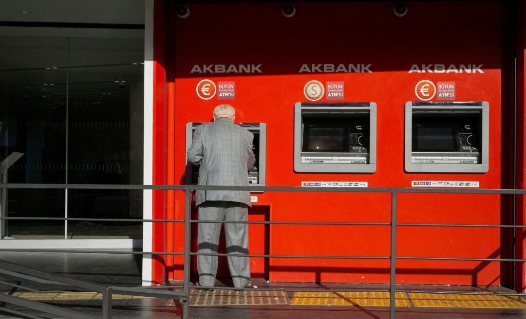 A man standing in front of the ATM machine