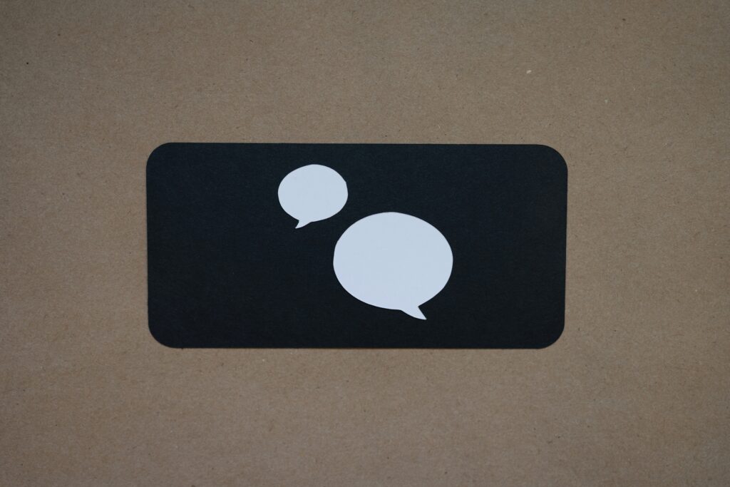 A black square with a white speech bubble on it.