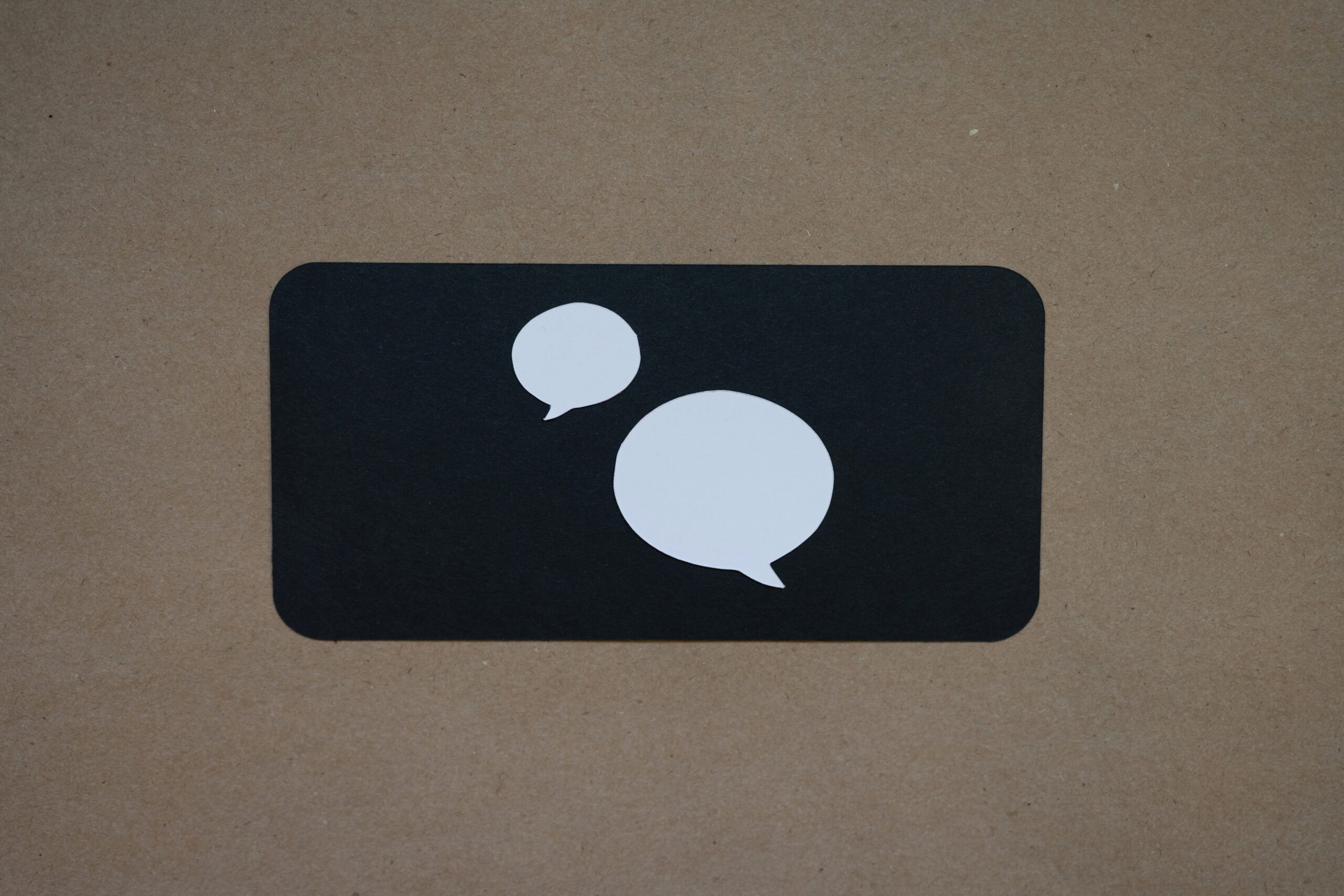 A black square with a white speech bubble on it.